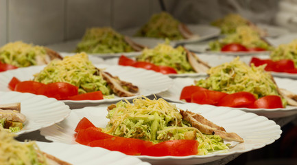 Several servings of cabbage salad and ham with tomato snack, preparation for a banquet