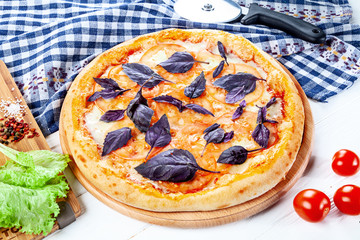 Close up view on pizza on white wooden background with ingridients. Italian cuisine. Ready to Eat. Restaurant, food menu, recipe, cafe concept. Lifestyle with copy space