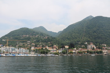 Fototapeta na wymiar View tLaveno Mombello at the Lago Maggiore from a car ferry, Italy