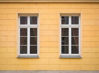 Fototapeta na wymiar White window on brick yellow wall