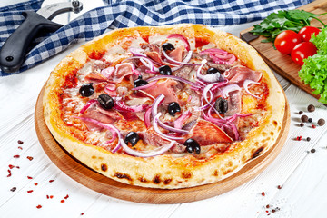 Close up view on pizza on white wooden background with ingridients. Italian cuisine. Ready to Eat. Restaurant, food menu, recipe, cafe concept. Lifestyle with copy space