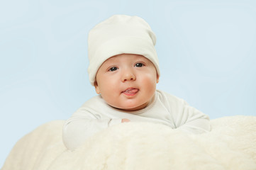 emotional newborn beautiful tender baby lies on a white blanket. The concept of health