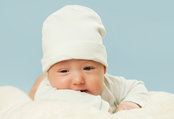 emotional newborn beautiful tender baby lies on a white blanket. The concept of health