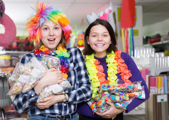  girls with bagfuls of multicolored confetti