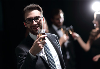 elegant man raising his glass with the toast
