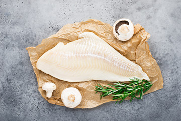 Fillet of sea white cod fish on parchment with fresh raw champignons before cooking. Zero waste kitchen. Healthy food seafood. Top view, space. - obrazy, fototapety, plakaty
