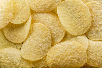 Potato chips on grey concrete table. Concept of fast food and snacks.