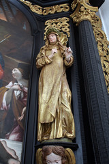 Fototapeta premium Saint Teresa on the altar of Our Lady of Sorrows, parish Church of the Immaculate Conception of the Virgin Mary in Lepoglava, Croatia