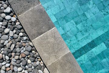 Closeup photo of pool edge which decorated with pebbles - 247414512