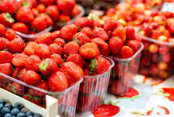 Boxes with fresh strawberries on the market - image