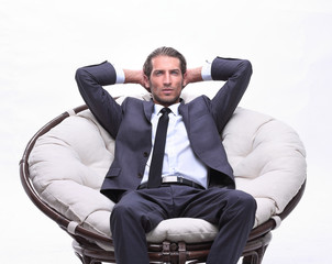 confident businessman sitting in chair