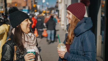 Two girls in the streets of New York on a sunny day