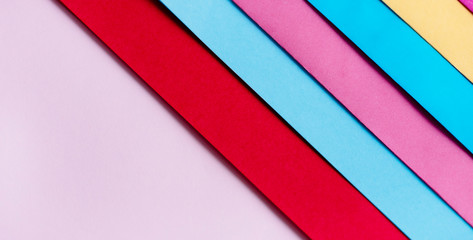 Trendy pastel colors in geometry shape flat lay. Colorful rainbow paper creative linear background.