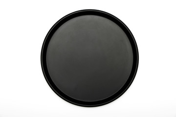 Black dish isolated on white background. A mockup of black dishes on a white background. View from above.