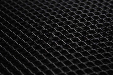 black metal mesh under dim light source