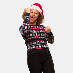 Young black woman in a trendy christmas sweater with print who does not surrender