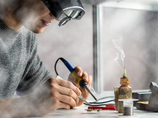 soldering iron with smoke from boiling rosin or colophony b