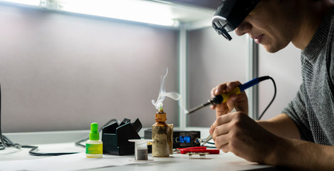 soldering iron with smoke from boiling rosin or colophony b