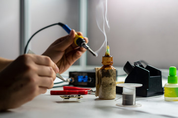 soldering iron with smoke from boiling rosin or colophony b