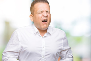 Obraz premium Middle age arab elegant man over isolated background with hand on stomach because indigestion, painful illness feeling unwell. Ache concept.