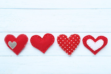 Red fabric hearts on wooden table