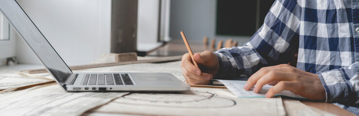 graphic designer doing calculations on his house schemes b