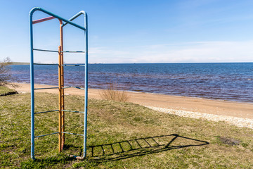 old soviet made climbing frame next to a Baltic beach on a summers day. 
