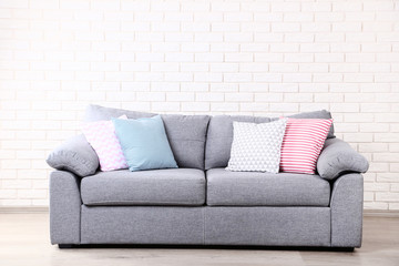 Colorful soft pillows on grey sofa