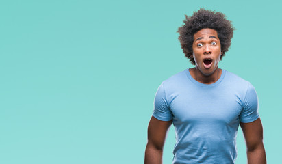 Afro american man over isolated background afraid and shocked with surprise expression, fear and...