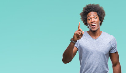 Afro american man over isolated background pointing finger up with successful idea. Exited and...