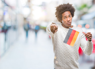 Afro american man flag of Germany over isolated background pointing with finger to the camera and to you, hand sign, positive and confident gesture from the front