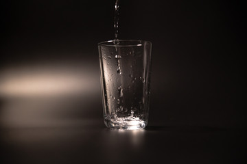 On a black background in a glass of water poured