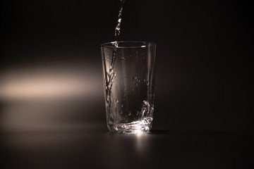 On a black background in a glass of water poured