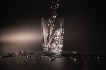 On a black background in a glass of water poured