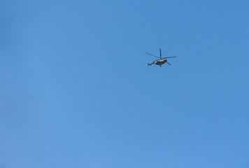 blue sky on which helicopter flies
