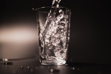On a black background in a glass of water poured