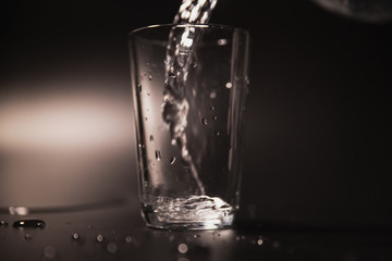 On a black background in a glass of water poured