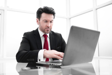 businessman uses a laptop for work.
