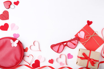 Paper hearts with gift boxes, sunglasses and padlock on white background