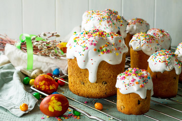 Springtime. Festive composition in rustic style. Easter cake and painted eggs on wooden table. Copy space.