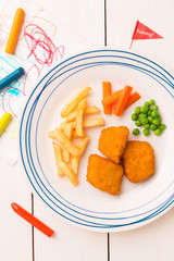 Kid's meal (dinner) - chicken nuggets, fries, carrot and green peas