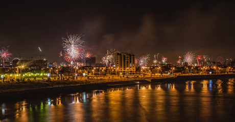 urban landscape salutes in honor of the new year near the river