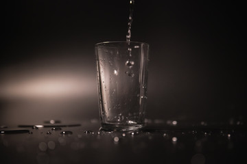 On a black background in a glass of water poured