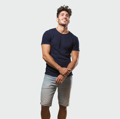 Fototapeta premium Young handsome man standing cheerful and with a big smile, confident, friendly and sincere, expressing positivity and success