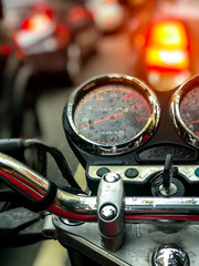 Fototapeta premium Wet motorcycle panel with traffic in the background