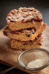 Cake with fruit and crumble on dark background