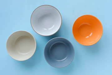 Assorted empty clean bowls and plates on blue