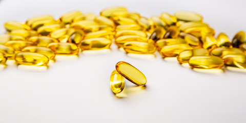 Omega-3 fish fat oil capsules on a white background.