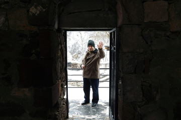 Obraz na płótnie Canvas Man in doorway in Geghard monastery