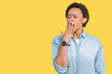 Young beautiful african american woman over isolated background bored yawning tired covering mouth...
